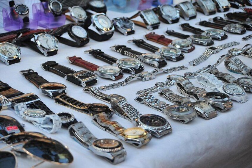 A variety of watches laid out on a table. 2