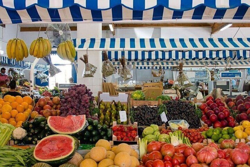 A market with various fruits and vegetables on display. 2