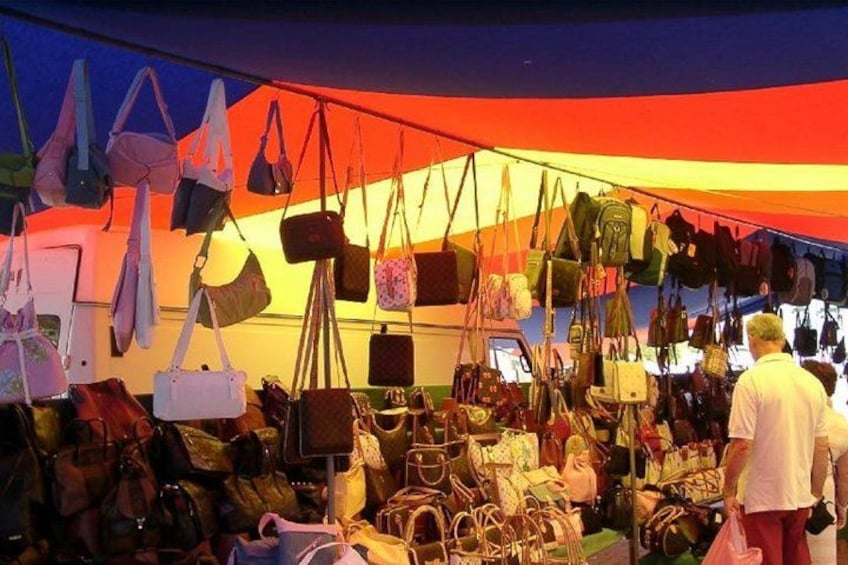 A tent with various bags hanging inside. 2