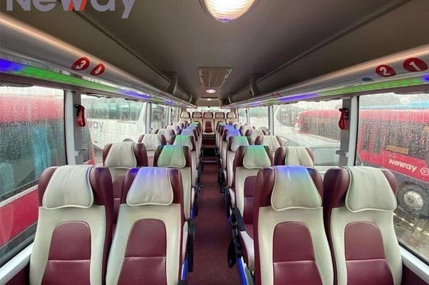 A train interior with rows of seats and windows. 5