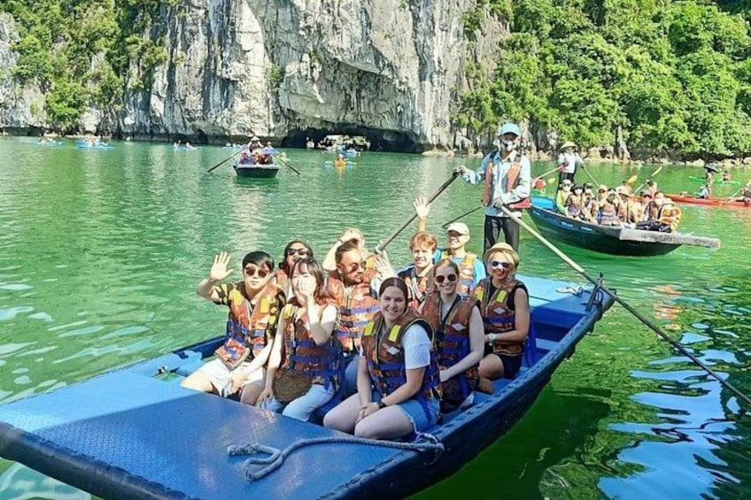 A group of people in a boat on a calm river, surrounded by cliffs and greenery. 3