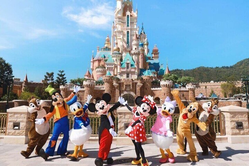 Mickey Mouse, Minnie Mouse, Donald Duck, Goofy, and Pluto in front of a castle. 1