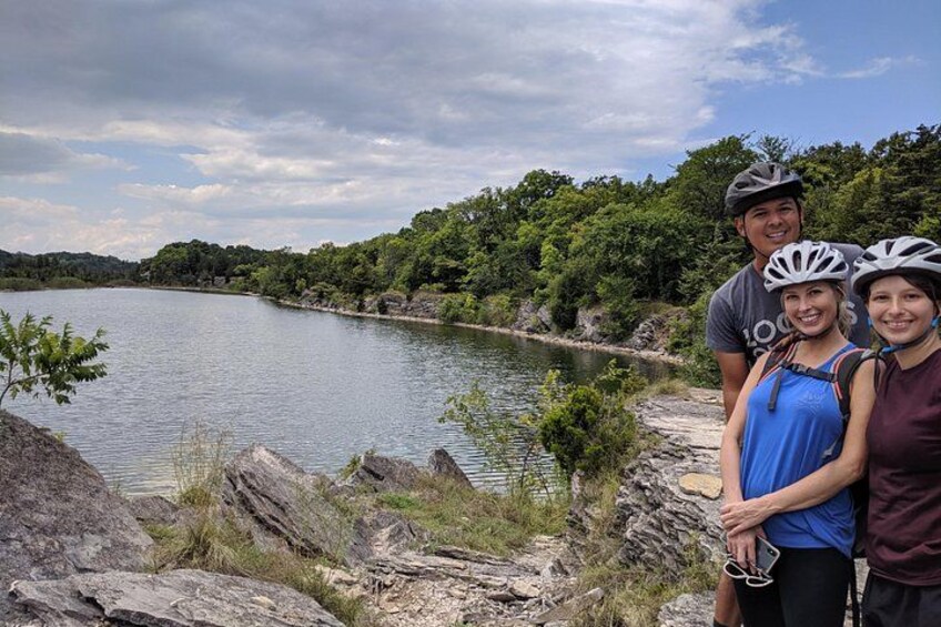 A lake, rocky shoreline, and dense greenery. 1