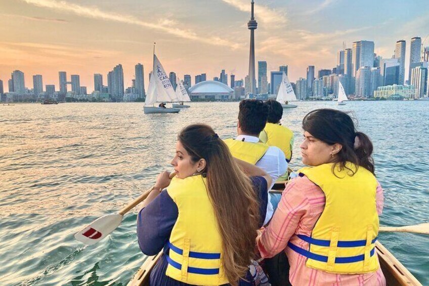 People in a boat with a city skyline in the background. 5