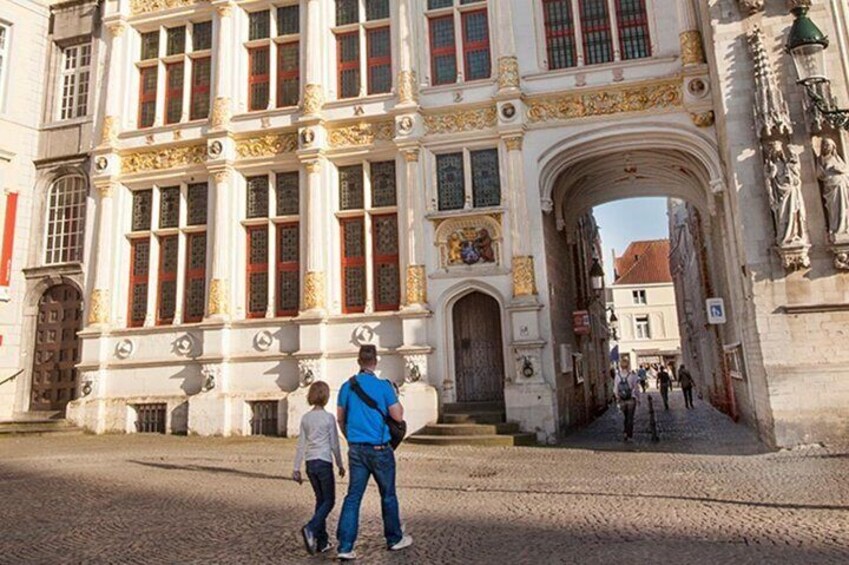 A historic building with ornate architecture and a cobblestone street. 1