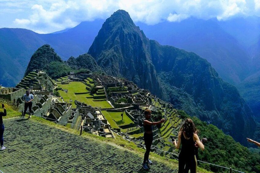 Machu Picchu ruins, terraced fields, and surrounding mountains. 4