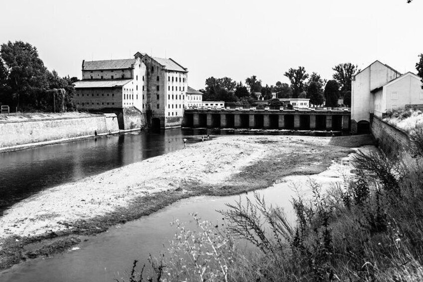 A river with a bridge, buildings, and a lock system. 2