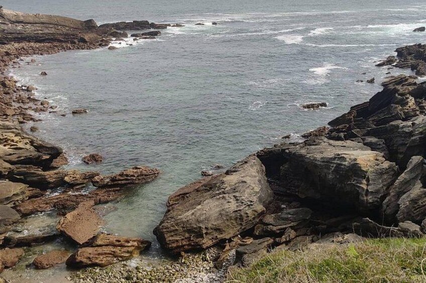 A rocky coastline with waves crashing against the shore. 5