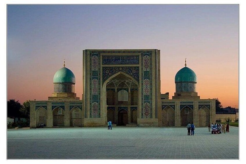 A large, ornate building with two domes and intricate tile work. 4