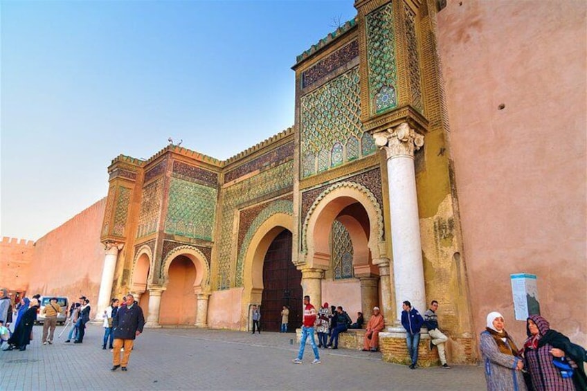 A historic building with intricate tile work and arches. 2