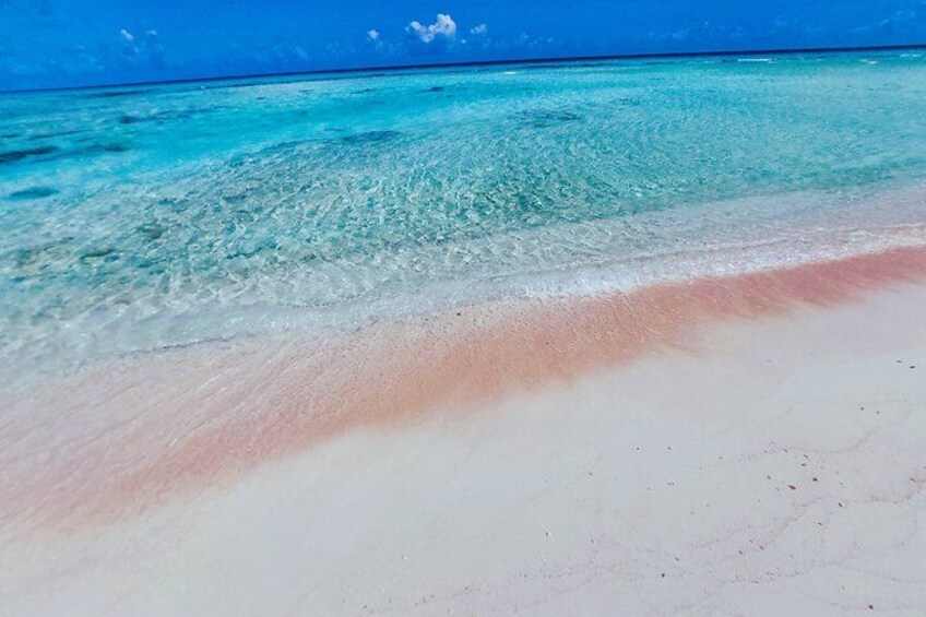 A beach with clear turquoise water and a white sandy shore. 2