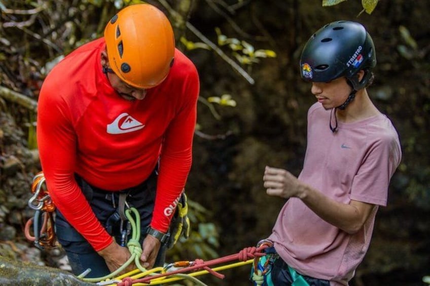 Two people in helmets and climbing gear near a rocky terrain. 5