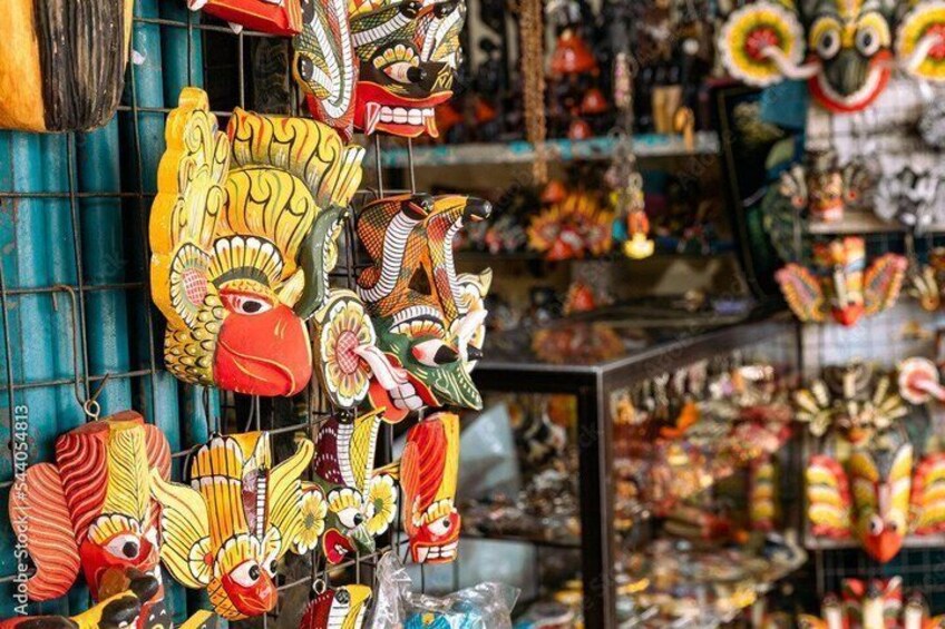A variety of colorful masks hanging on a rack. 1