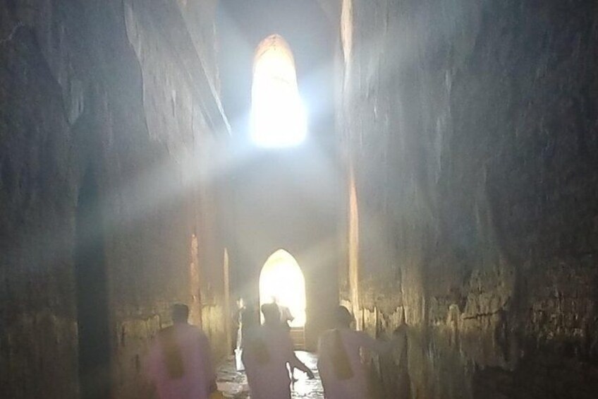 A cave with a bright light at the end of a passageway. 2