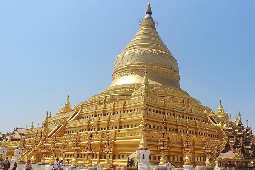 A large golden stupa with intricate carvings and smaller golden structures around it. 3