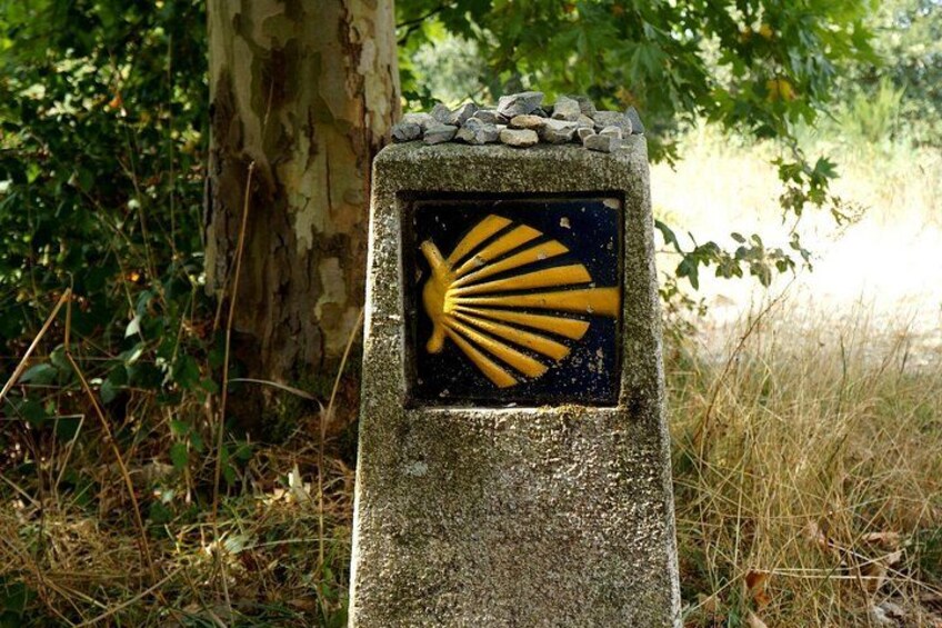 A stone monument with a yellow sunburst symbol. 2