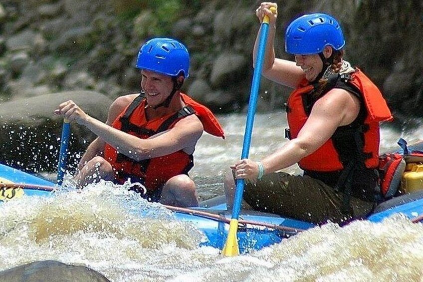Two people kayaking on a river. 1