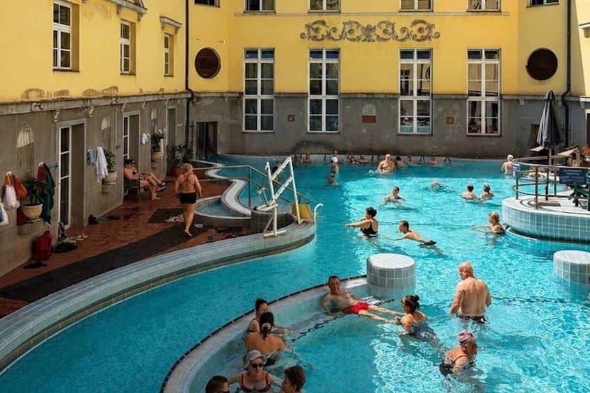 A swimming pool with people swimming and lounging. 2