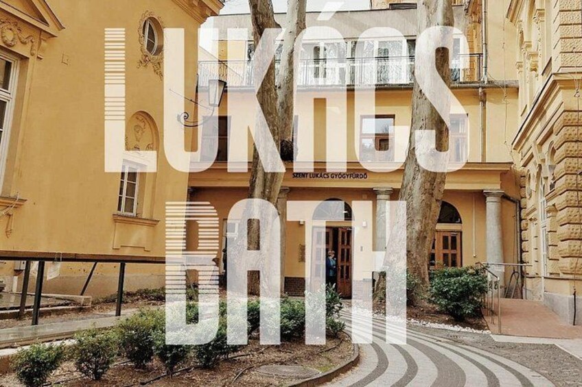 A building with classical architecture, a tree in the foreground, and a curved pathway. 4