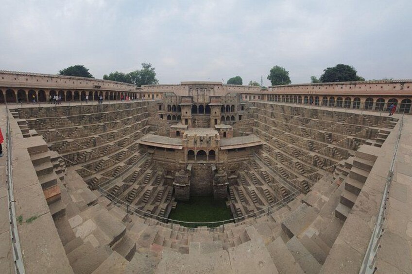 A large, ancient amphitheater with tiered seating and a central stage. 4