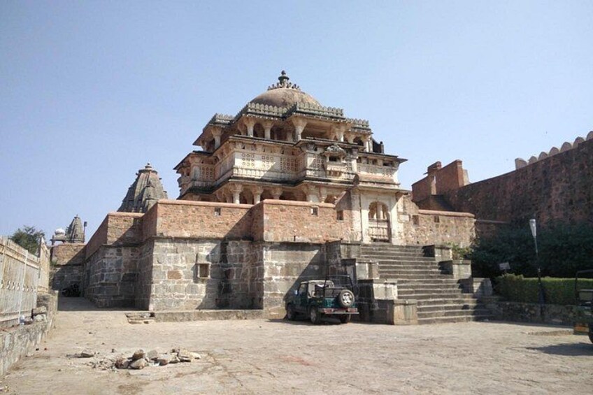 A historic building with a large dome and multiple levels, surrounded by a fortified wall. 5