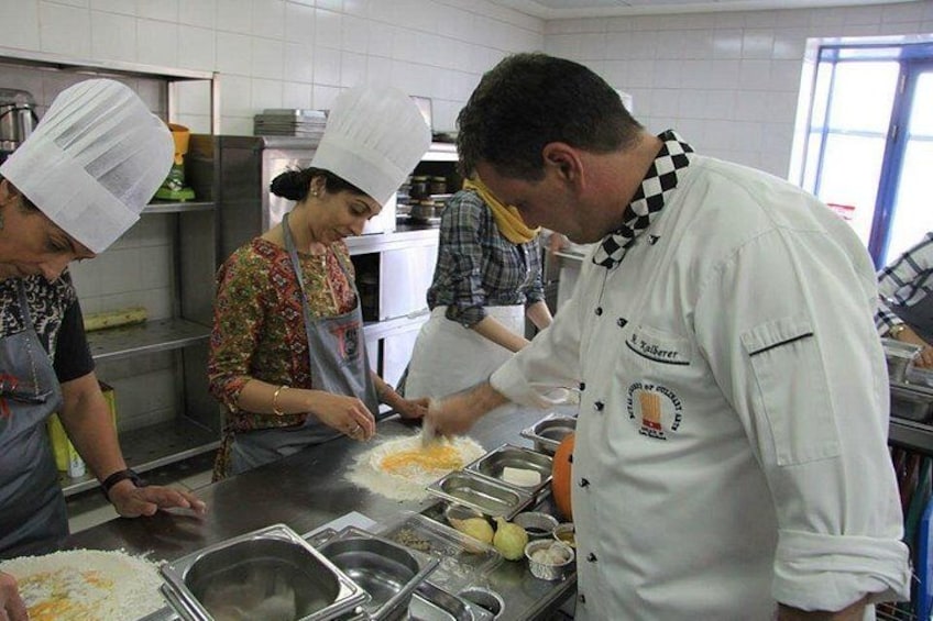 Chefs in a kitchen preparing food. 3