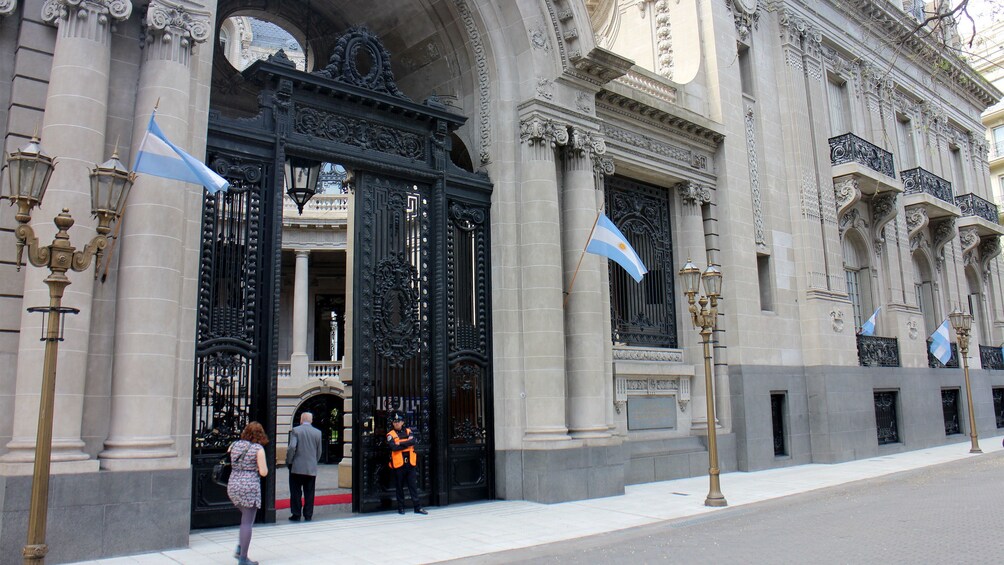 guard standing in front of a gated entrance in Argentina