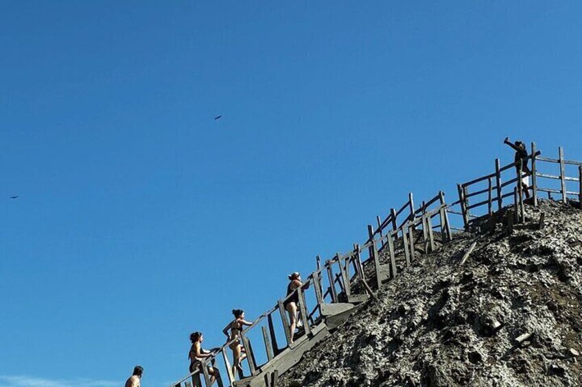 A rocky mountain with a wooden staircase and railings. 5