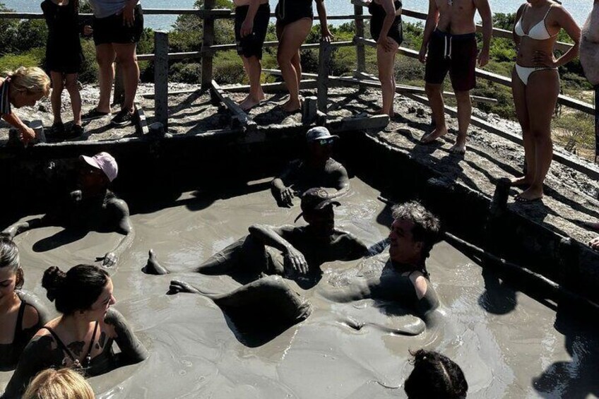 People in a hot spring with water flowing around them. 3