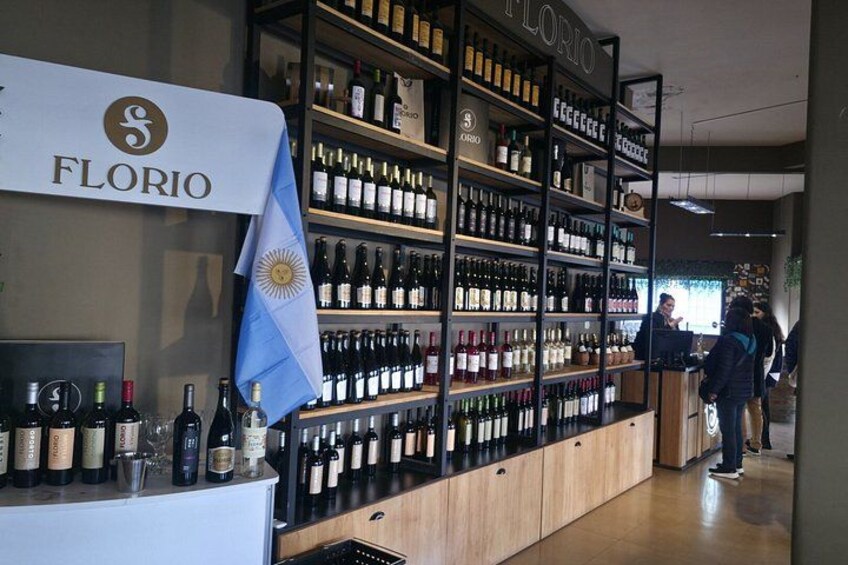 A wine store with shelves of wine bottles and a sign that reads 'FLORIO'. 5