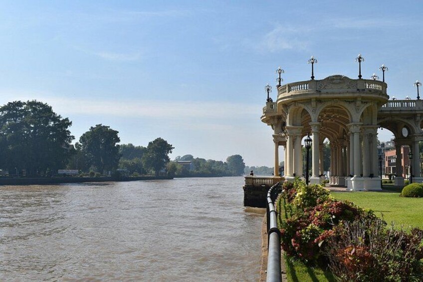 A river with a gazebo and greenery. 2