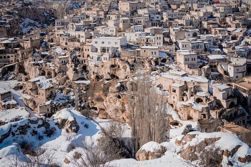 A snow-covered mountainous village with traditional architecture. 4