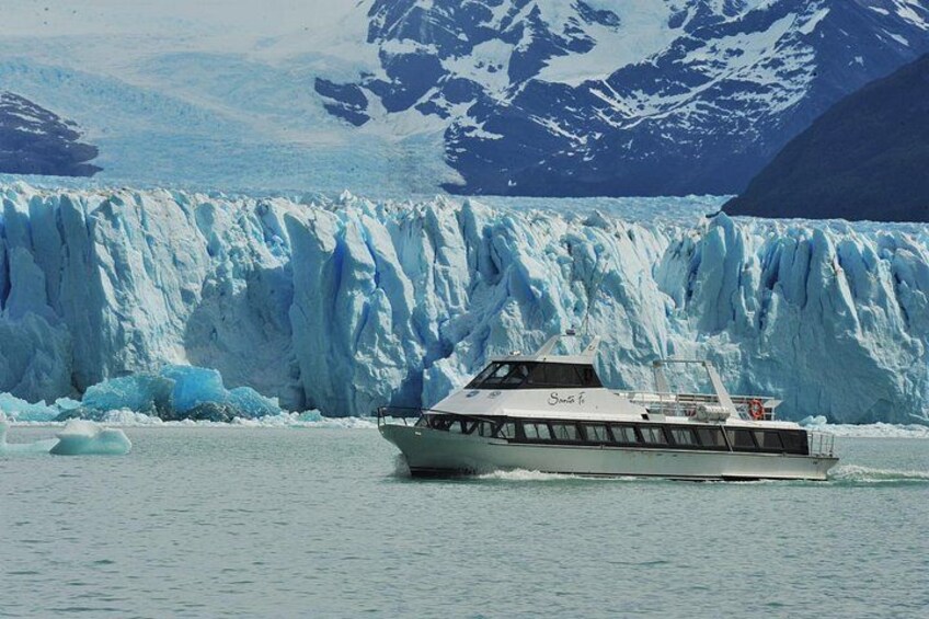 A boat on a glacier with a mountainous backdrop. 4
