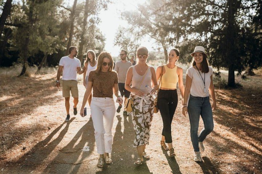 A group of people walking on a dirt path in a wooded area. 2