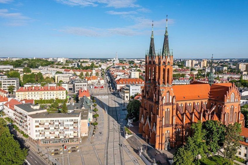 A cathedral with twin spires, a cityscape with buildings, and a clear sky. 3