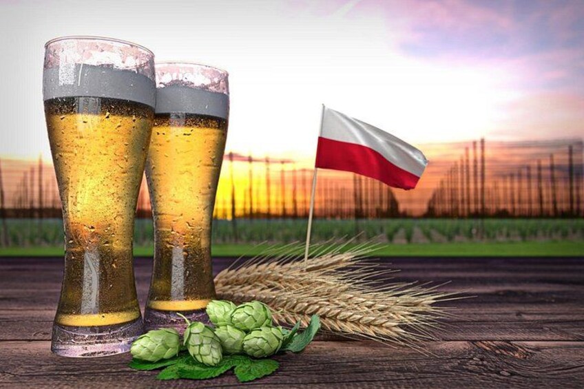 Two glasses of beer, a flag, and wheat on a wooden surface. 1