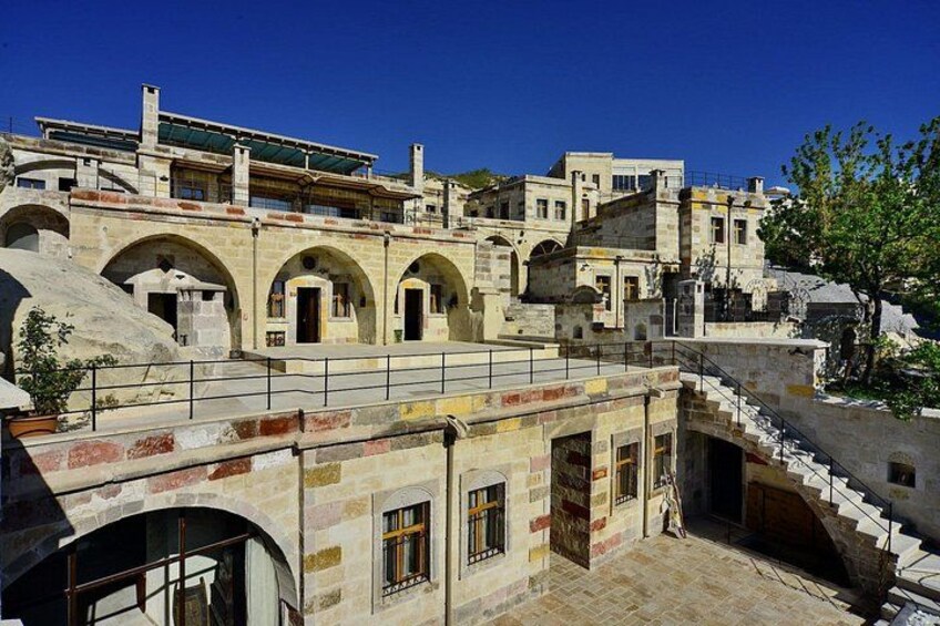 A historic stone building with arches and a staircase. 1