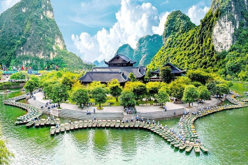 A traditional Chinese building surrounded by water and greenery. 1