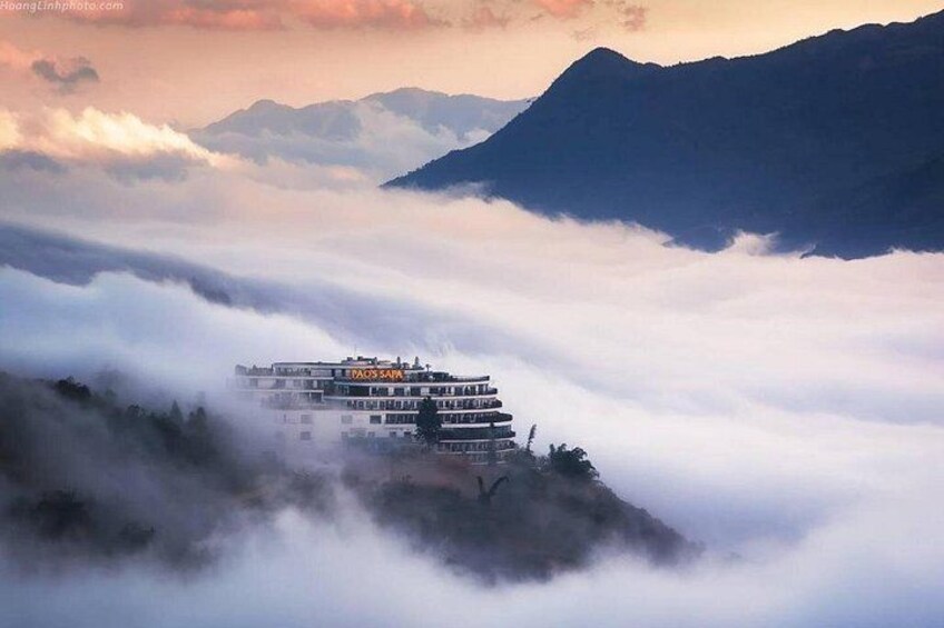 A building on a mountain peak surrounded by clouds. 5