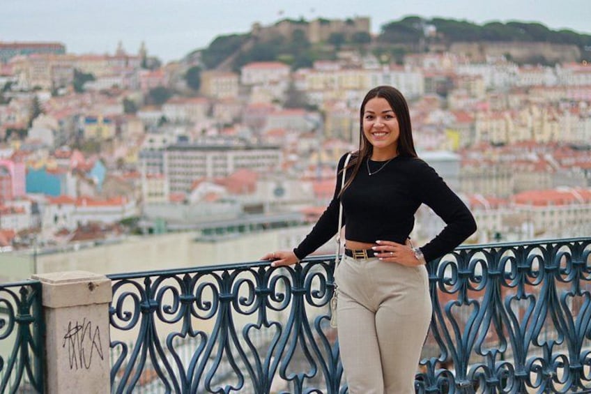 A person standing on a bridge with a cityscape in the background. 4