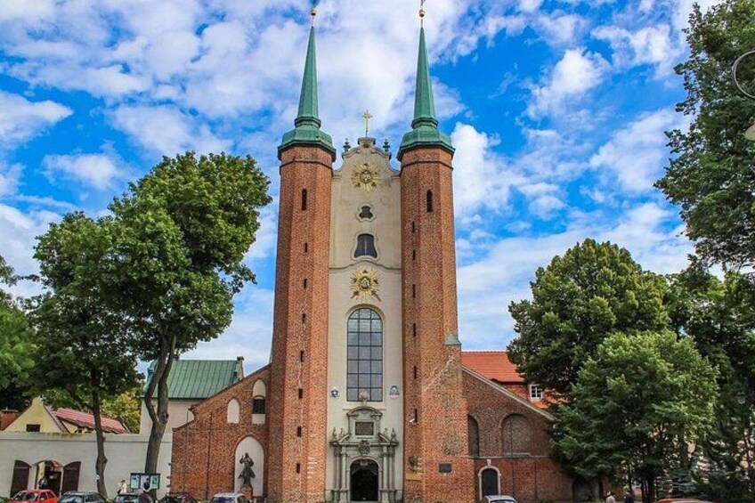 A church with two towers and a large arched window. 1