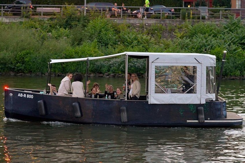 A boat with people on it, moving on water. 4
