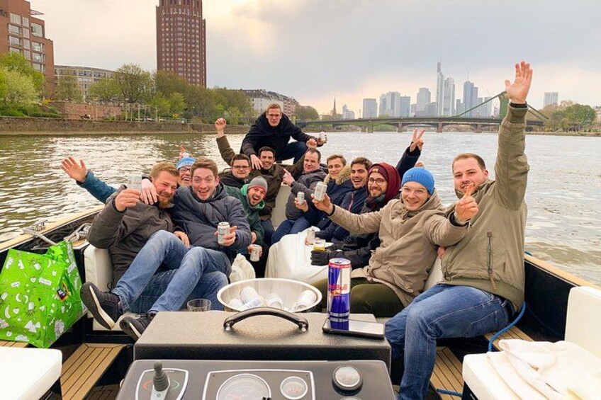 A group of people on a boat with a city skyline in the background. 2