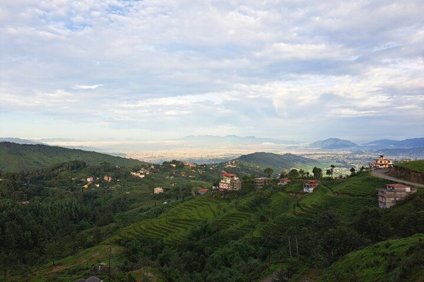 A mountainous landscape with terraced fields and scattered buildings. 2