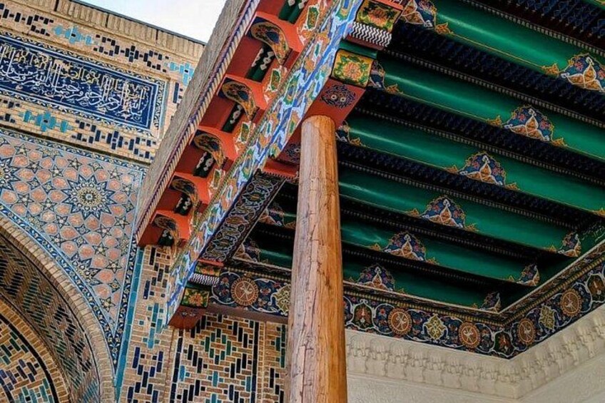 A detailed view of a building's ornate architecture, including intricate tile work and colorful patterns. 5