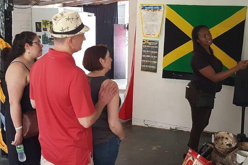 A group of people in a room with a flag on the wall. 3