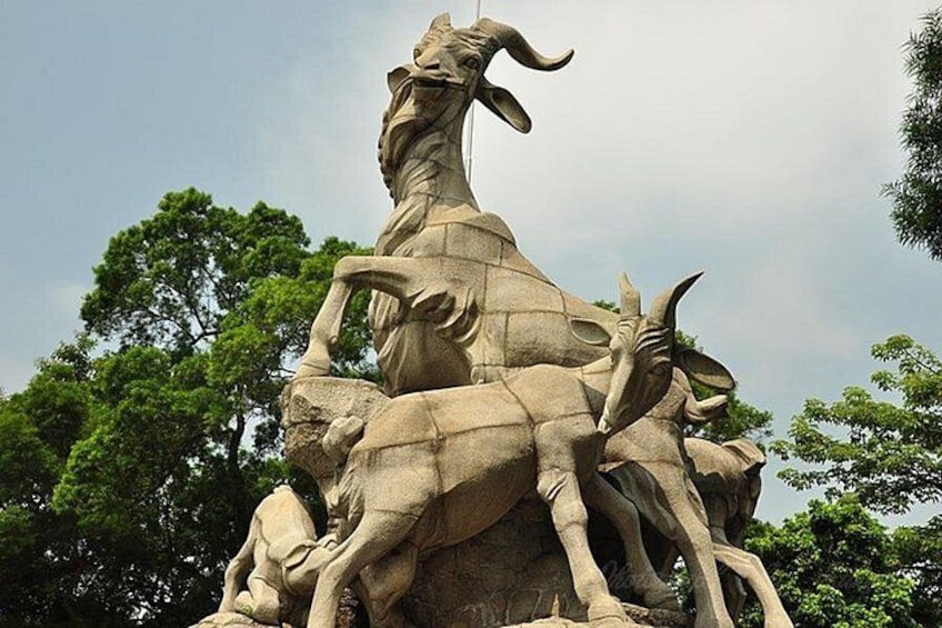A stone sculpture of a ram with a woman and two goats. 1