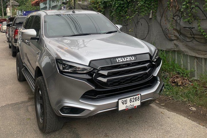 A silver Isuzu SUV parked on a street with a license plate number 3-1-6268. 3