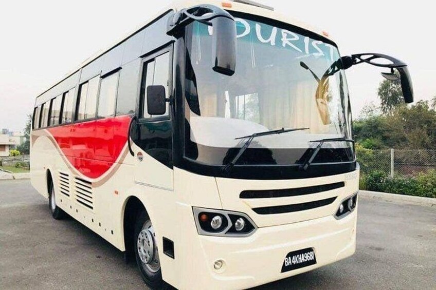 A white and red bus with the word 'TOURIST' on the front windshield. 1