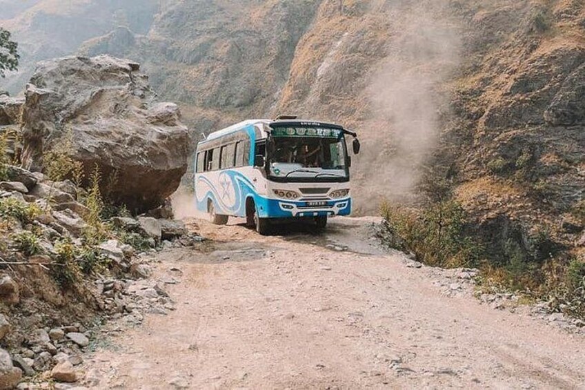 A bus navigating a rugged, rocky terrain. 5